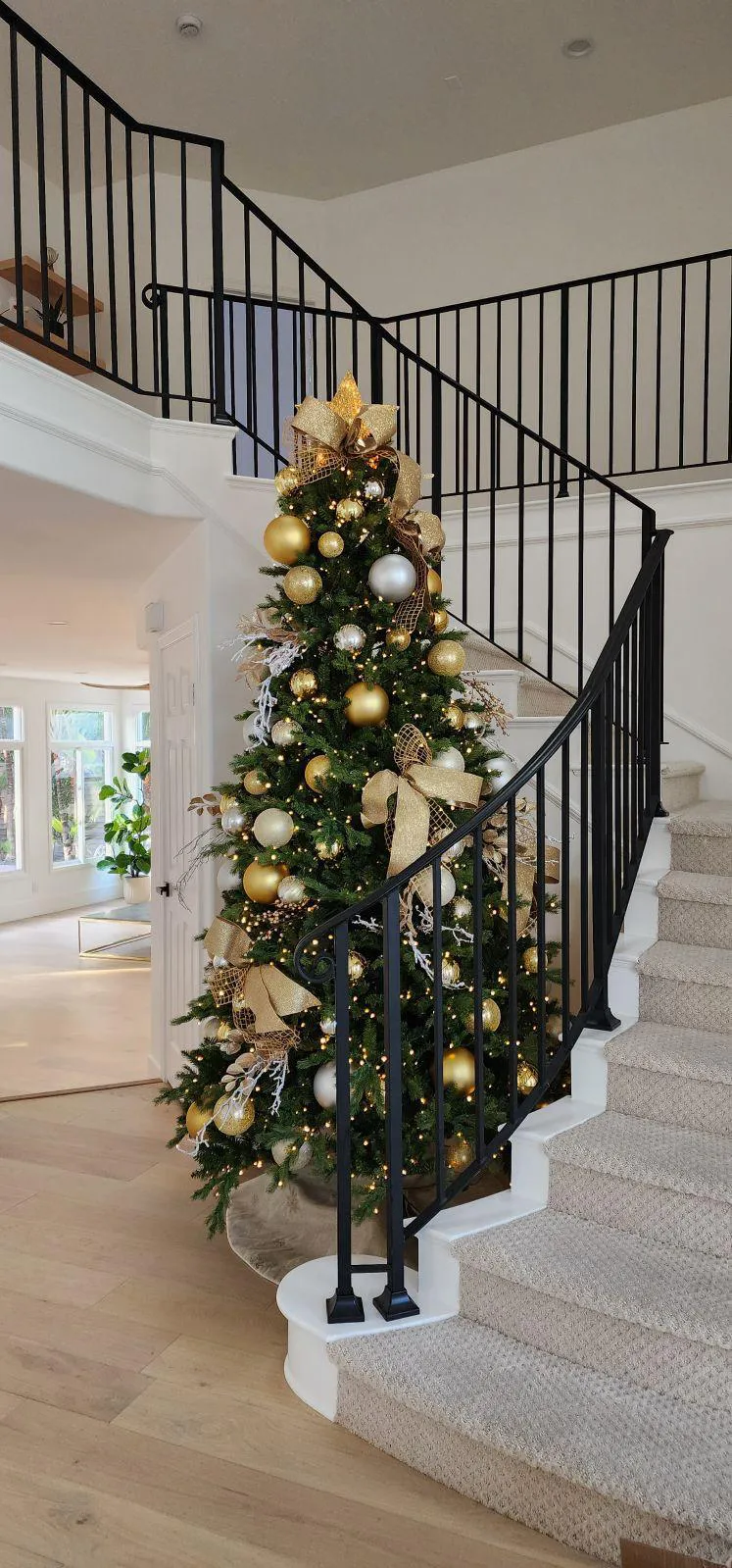 Gold and silver Christmas tree decorations with ribbons and lights for modern holiday home decor